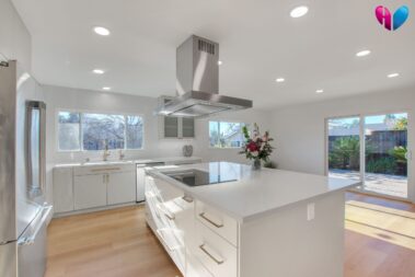 new kitchen remodel with kitchen island induction stovetop and custom cabinets